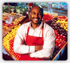 Managed Behavioral Health Members: African-American male grocery employee standing in produce department